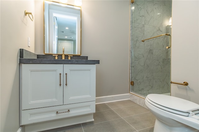 bathroom featuring tile patterned flooring, walk in shower, vanity, and toilet