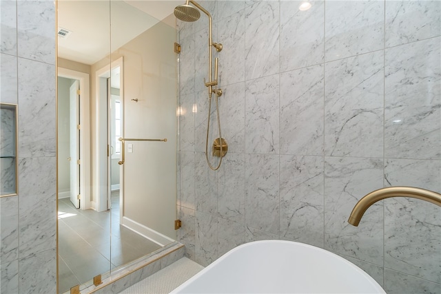 bathroom featuring separate shower and tub and tile patterned flooring