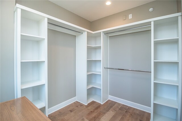 spacious closet featuring hardwood / wood-style floors