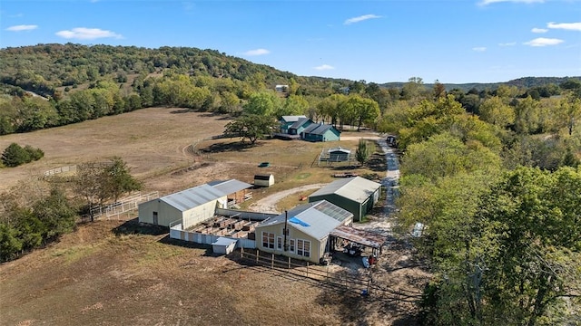 drone / aerial view featuring a rural view and a forest view