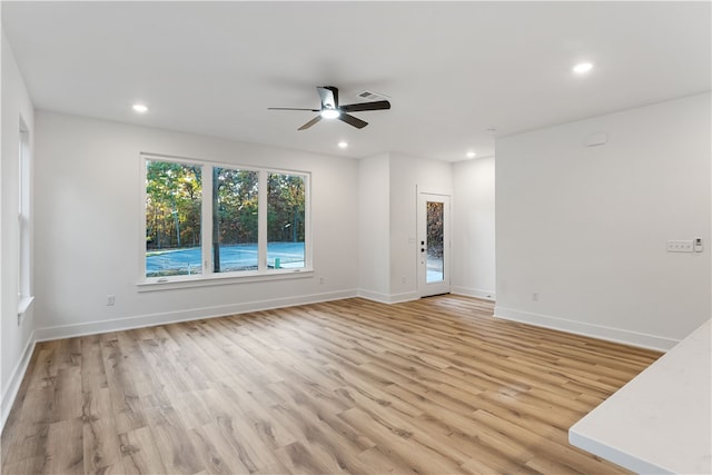 unfurnished room featuring light hardwood / wood-style flooring and ceiling fan