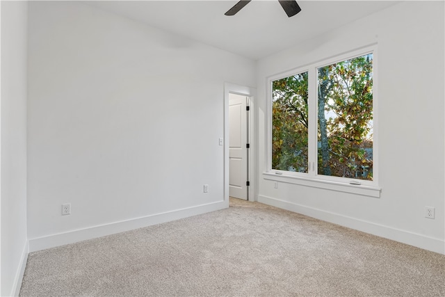 unfurnished room featuring light carpet and ceiling fan