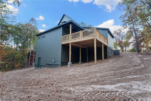 rear view of house with a wooden deck