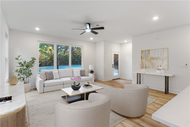 living room featuring light wood-type flooring and ceiling fan