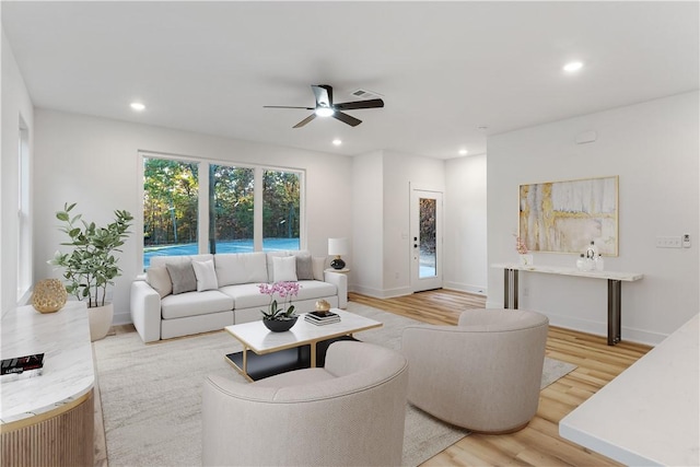 living area featuring baseboards, ceiling fan, recessed lighting, and wood finished floors