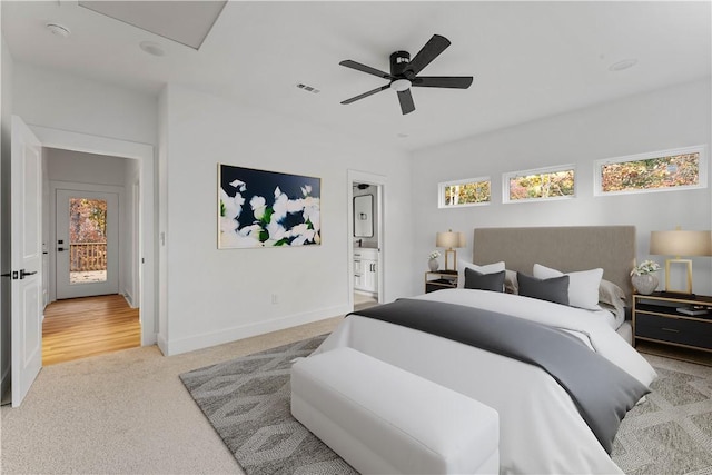 carpeted bedroom with a ceiling fan, baseboards, visible vents, and ensuite bath
