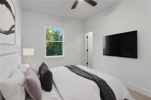 bedroom featuring carpet floors, baseboards, and a ceiling fan