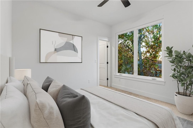 bedroom with carpet floors, a ceiling fan, and baseboards
