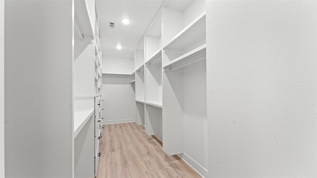 spacious closet featuring light wood-type flooring