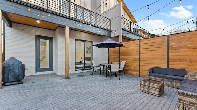 view of patio featuring a balcony, grilling area, and outdoor lounge area