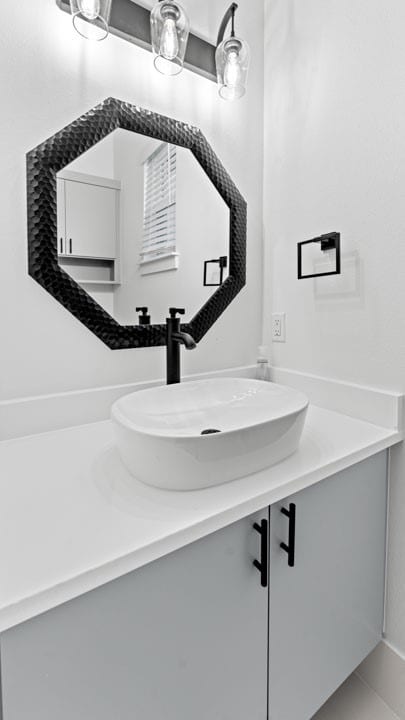 bathroom featuring tile patterned flooring and vanity