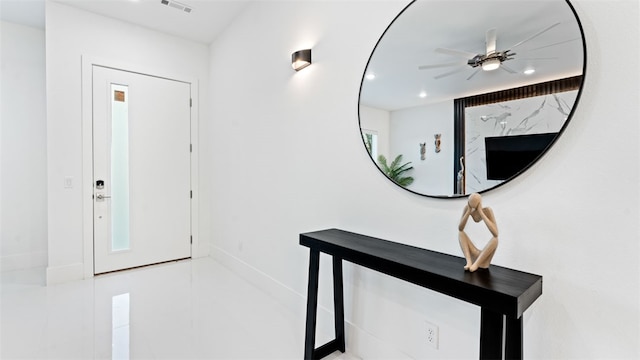 tiled entryway featuring ceiling fan