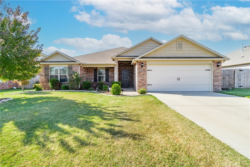 view of front of house with a garage and a front yard