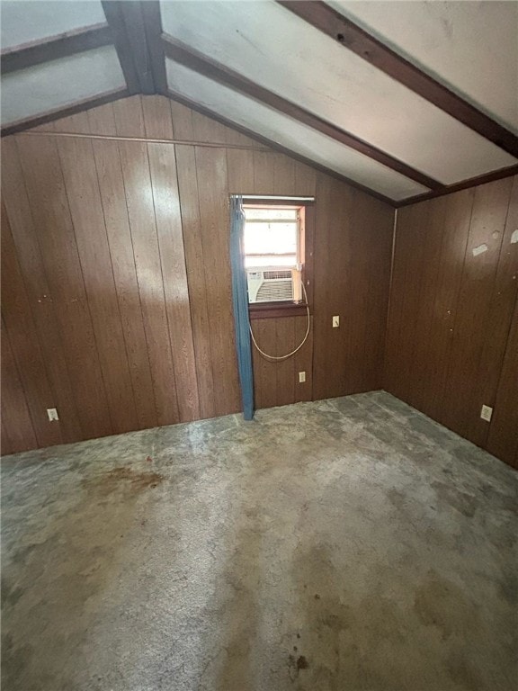 additional living space featuring carpet floors, cooling unit, wooden walls, and lofted ceiling with beams