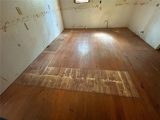 spare room featuring wood-type flooring