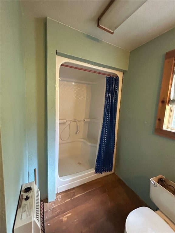 bathroom with a shower with curtain and toilet