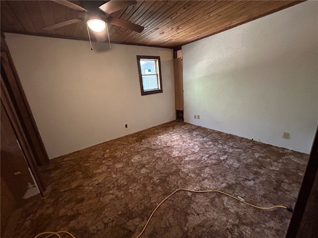 empty room featuring ceiling fan and wooden ceiling