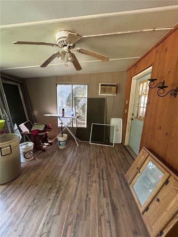 miscellaneous room with wood walls, lofted ceiling, ceiling fan, hardwood / wood-style flooring, and a wall mounted AC