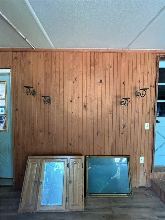 details with wood-type flooring and wood walls