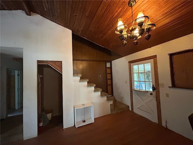 interior space with wooden ceiling, vaulted ceiling with beams, wood walls, and a chandelier