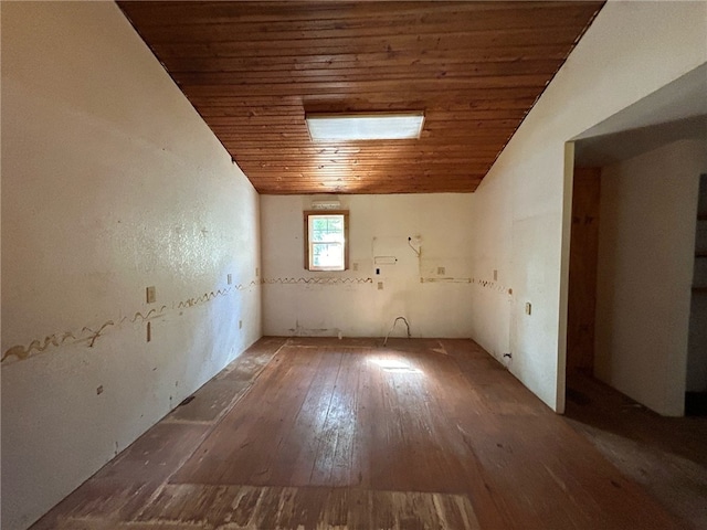 unfurnished room with lofted ceiling, hardwood / wood-style flooring, and wooden ceiling