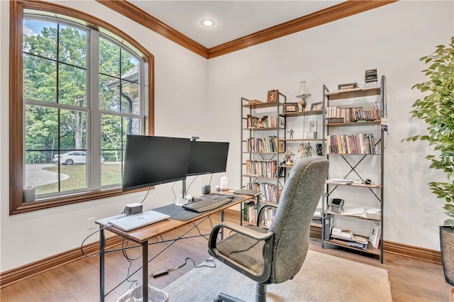 home office with crown molding and light wood-type flooring