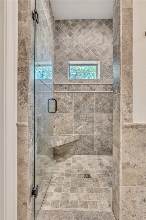 bathroom with a shower with door