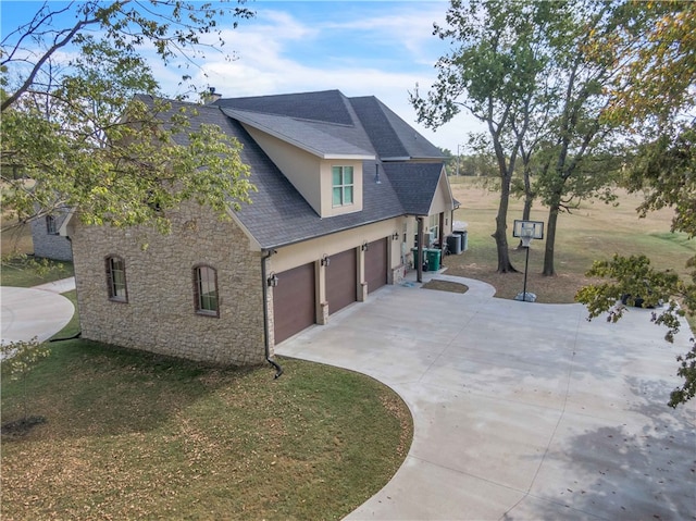 view of side of home with roof with shingles, stucco siding, driveway, stone siding, and an attached garage