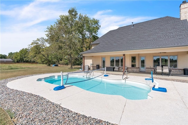 pool with a patio area and a ceiling fan