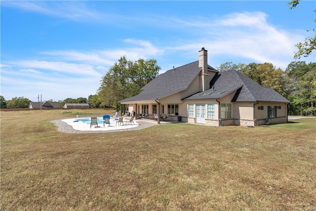 back of property featuring a yard and a patio