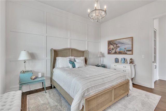 bedroom with dark wood-type flooring and an inviting chandelier