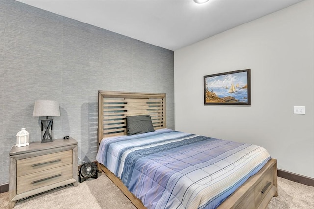 bedroom featuring light carpet and baseboards