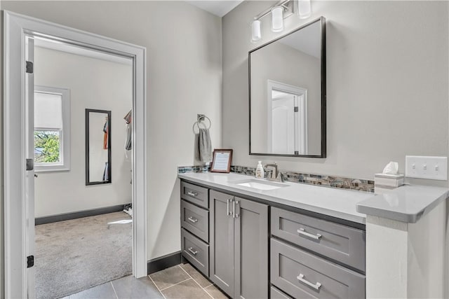bathroom featuring tile patterned floors, vanity, and baseboards