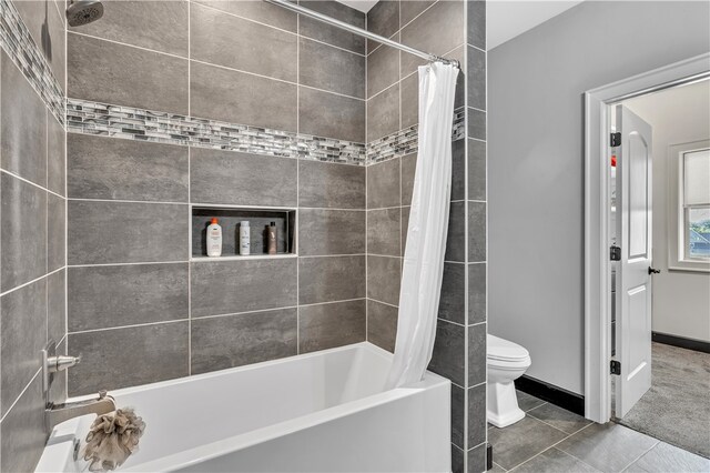 bathroom with toilet, tile patterned floors, and shower / bathtub combination with curtain