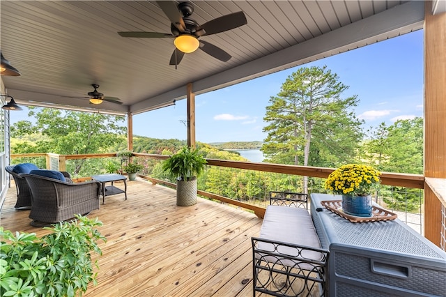 deck featuring a water view and ceiling fan