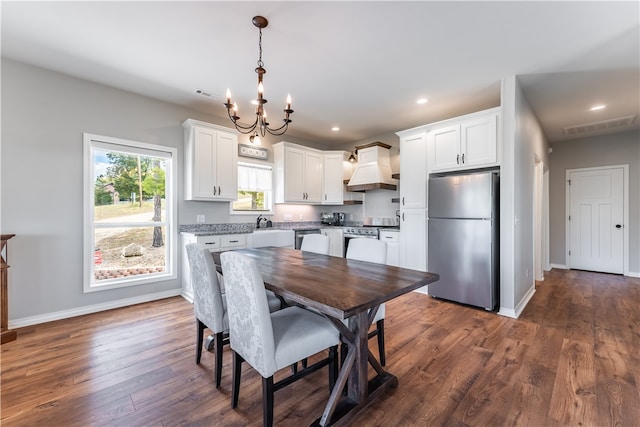 dining room with a chandelier, sink, and dark hardwood / wood-style flooring