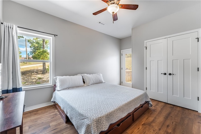 bedroom featuring ceiling fan, a closet, and dark hardwood / wood-style flooring