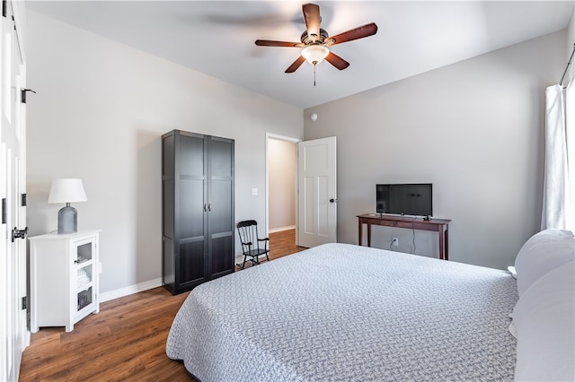 bedroom with ceiling fan and dark wood-type flooring