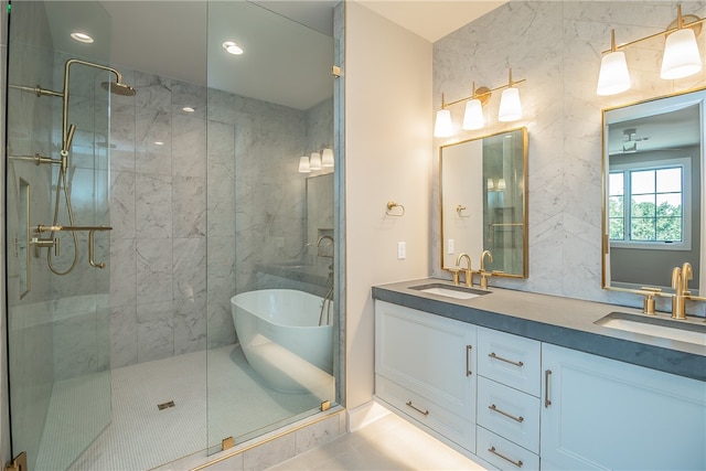 bathroom with independent shower and bath, tile patterned flooring, vanity, and tile walls