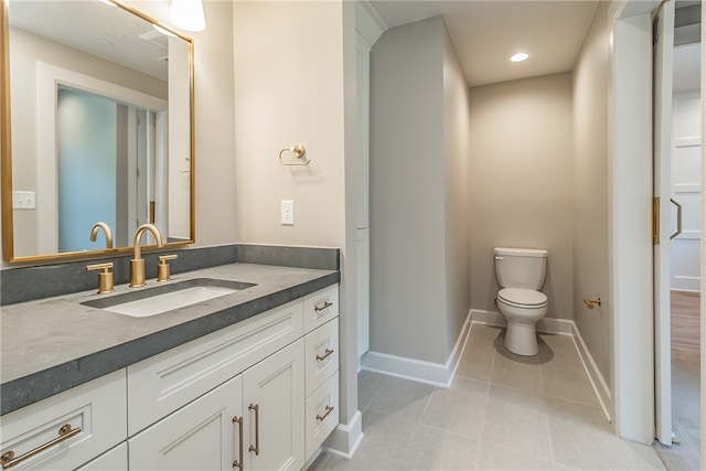 bathroom with vanity, toilet, and tile patterned floors