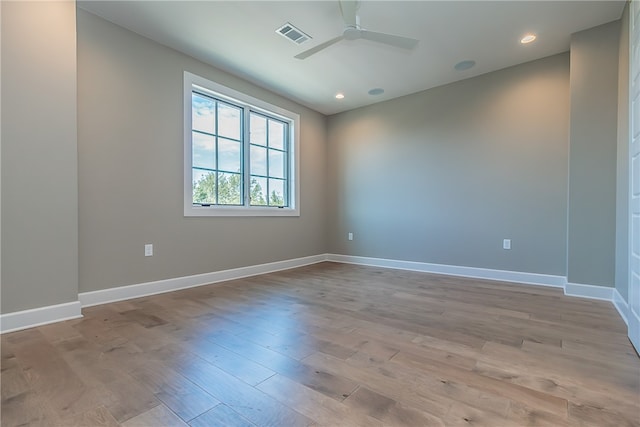 empty room featuring ceiling fan and light hardwood / wood-style floors