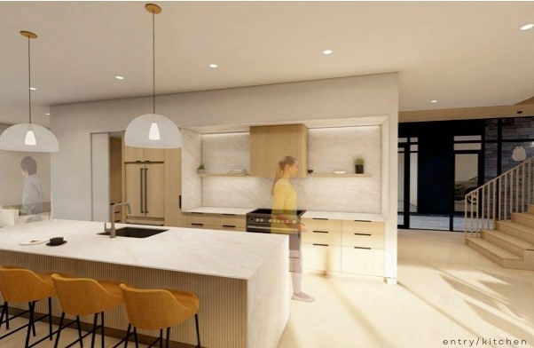 kitchen with decorative light fixtures, a peninsula, stainless steel electric stove, a kitchen bar, and a sink