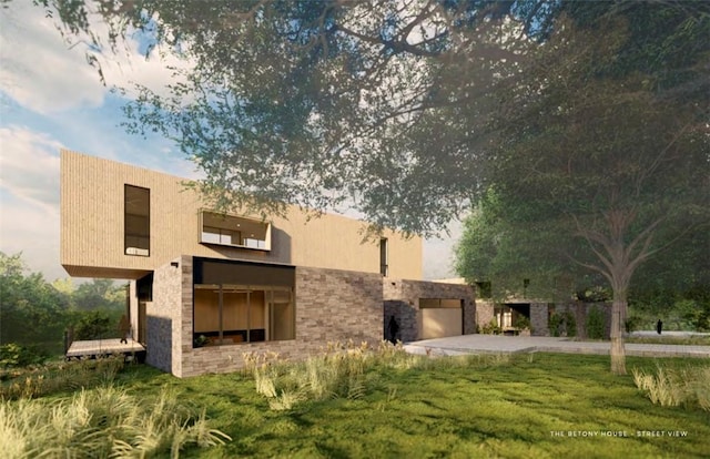 rear view of property with stone siding, a yard, an attached garage, and stucco siding