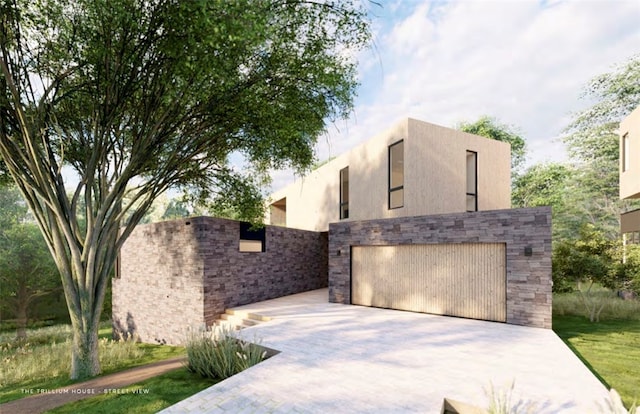 view of front of property featuring a garage, stone siding, and stucco siding