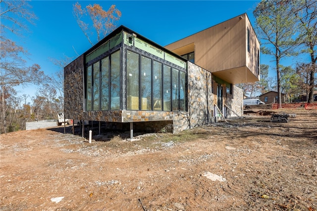 view of side of home with a sunroom