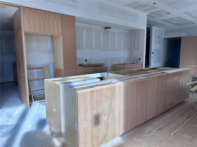 kitchen with light brown cabinets, modern cabinets, and a kitchen island