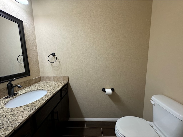 bathroom featuring vanity, toilet, and tile patterned floors