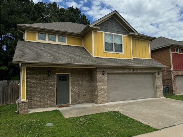 view of front of house with a front yard and a garage