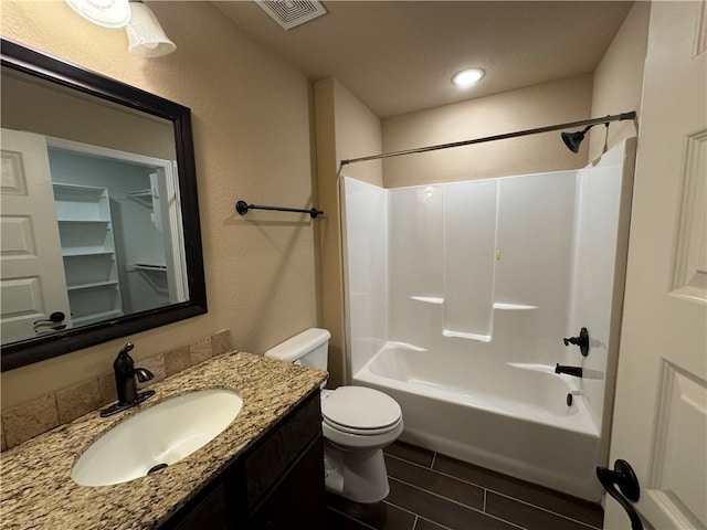 full bathroom featuring  shower combination, vanity, and toilet