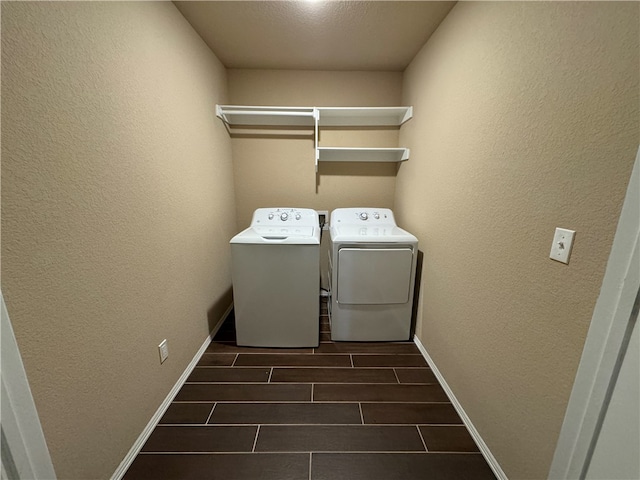 washroom with a textured ceiling and separate washer and dryer